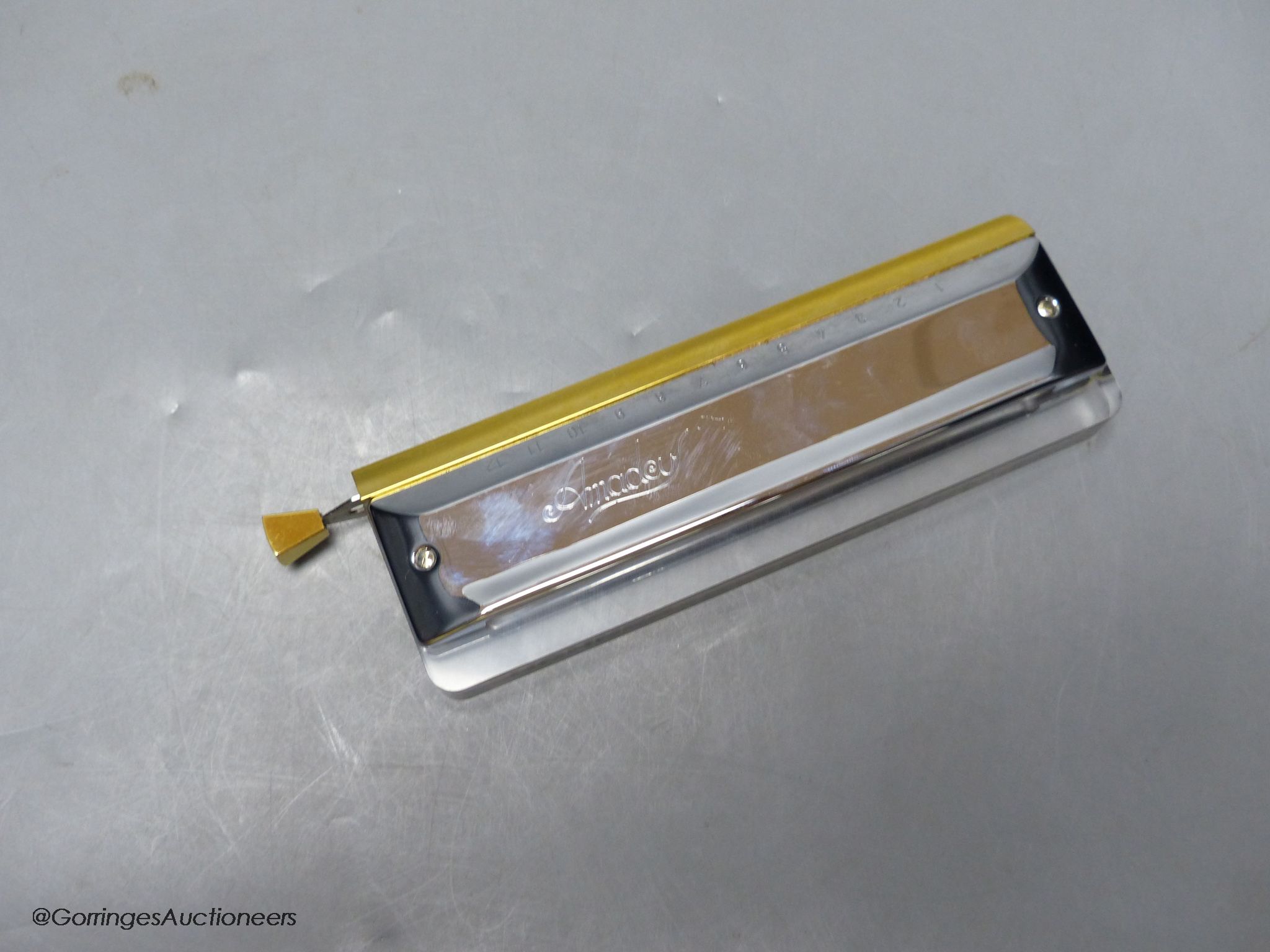 An M.Hohner Amadeus cased harmonica
